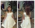 A beautiful sleeveless flower girl dress with bow.