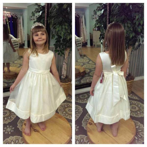 A beautiful sleeveless flower girl dress with bow.