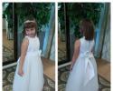 This adorable flower girl dress features a button back and bow in back.