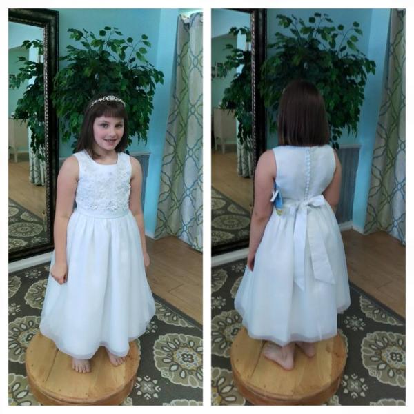 Lovie's Recycled Weddings offers affordable options for flower girl dresses. This dress has flower details on the front with a button up back. (Size 10) 