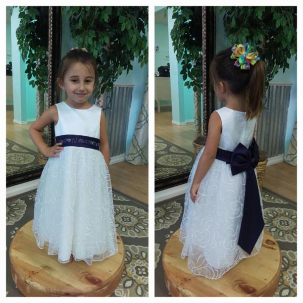 Find your little lady's flower girl dress at Lovie's Recycled Weddings. This adorable dress is complete with rose tulle and royal blue bow to match the bridesmaid's dress. (Size 2t)