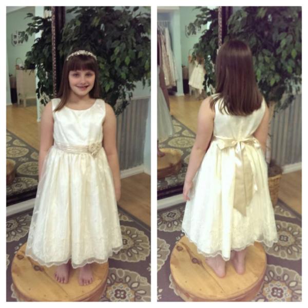 At Lovie's Recycled Weddings you will find flower girl dresses in all sizes. Whether you are looking for simple and classic, or something modern and fun.. we have something just for you and your bridal party. She looks like a little angel in this ivory dress. (Size 12)