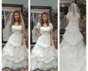 Bridal gown with full skirt and removeable capped sleeves
